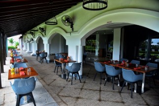 Outdoor Dining - Restaurant near Varkala Beach Outdoor dining area at a restaurant near Varkala beach, featuring modern seating and a scenic view, perfect for a relaxing meal.