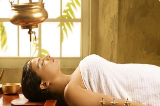 Shirodhara Treatment - Ayurvedic Spa in Varkala Relaxing Shirodhara treatment at an Ayurvedic spa in Varkala, where a steady stream of warm oil is gently poured on the forehead, promoting deep relaxation and wellness.