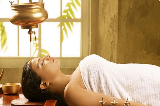 Shirodhara Treatment - Ayurvedic Spa in Varkala Relaxing Shirodhara treatment at an Ayurvedic spa in Varkala, where a steady stream of warm oil is gently poured on the forehead, promoting deep relaxation and wellness.