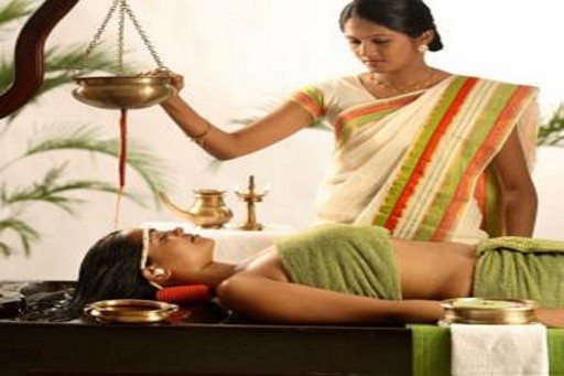 Therapy - Ayurvedic Treatment in Varkala Traditional Ayurvedic treatment in Varkala, with a therapist performing Shirodhara therapy, providing a calming and holistic wellness experience.