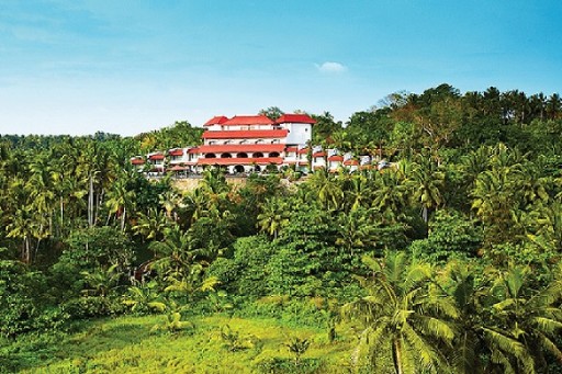 Scenic View - Hotel in Varkala Scenic view of a hotel in Varkala surrounded by lush greenery and palm trees, offering a serene and picturesque setting for guests.