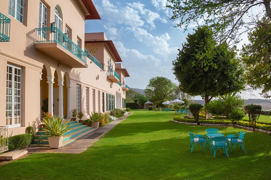 Facade of Ramgarh Lodge, IHCL SeleQtions, featuring elegant lighting and lush greenery in Jamwa Ramgarh.
