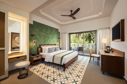 Deluxe Room with Balcony - The Yellow House Goa Deluxe room with balcony at The Yellow House, Goa, featuring modern furnishings and a private balcony. Ideal for guests seeking a hotel in Anjuna Beach.
