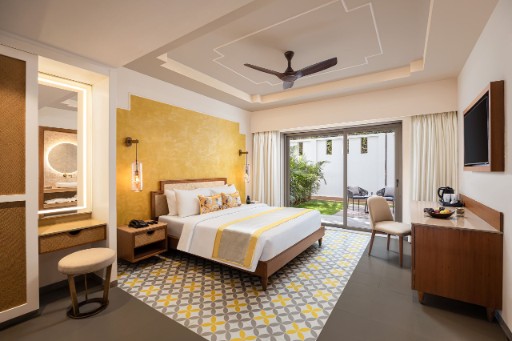 Deluxe Room with Garden View Deluxe room with garden view at The Yellow House, Goa, showcasing elegant decor and a relaxing atmosphere