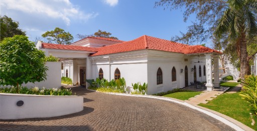 The Yellow House Goa - Facade View Facade view of The Yellow House, Goa, showcasing its heritage architecture and lush surroundings, a heritage hotel in Goa.
