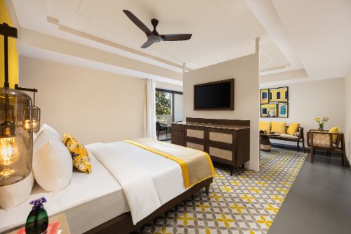 Premium Room with Balcony - The Yellow House Goa Premium room with balcony at The Yellow House, Goa, featuring luxurious furnishings and a scenic view. Perfect for guests looking for premium hotels in Anjuna Beach.