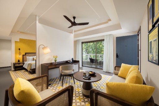 Premium Room with Balcony - The Yellow House Goa Premium room with balcony at The Yellow House, Goa, featuring luxurious furnishings and a scenic view. Perfect for guests looking for premium hotels in Anjuna Beach.