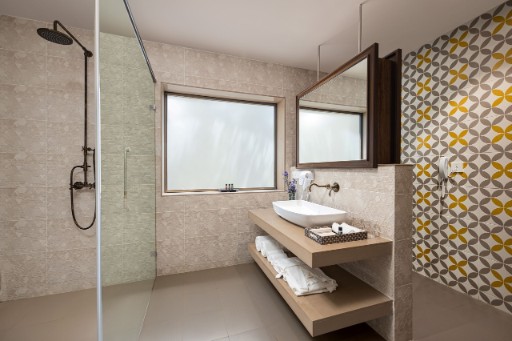 Premium Bathroom - The Yellow House Goa Bathroom in premium room with balcony at The Yellow House, Goa, offering a luxurious setting with modern amenities.