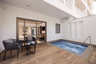 Premium Room with Plunge Pool Premium room with balcony at The Yellow House, Goa, showcasing elegant decor and a beautiful view.