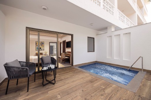 Premium Room with Plunge Pool Premium room with balcony at The Yellow House, Goa, showcasing elegant decor and a beautiful view.